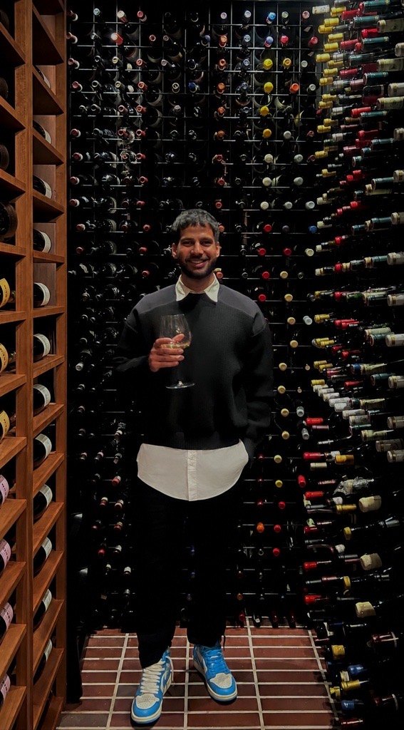 Vaibhav Saxena in a wine cellar, raising a glass